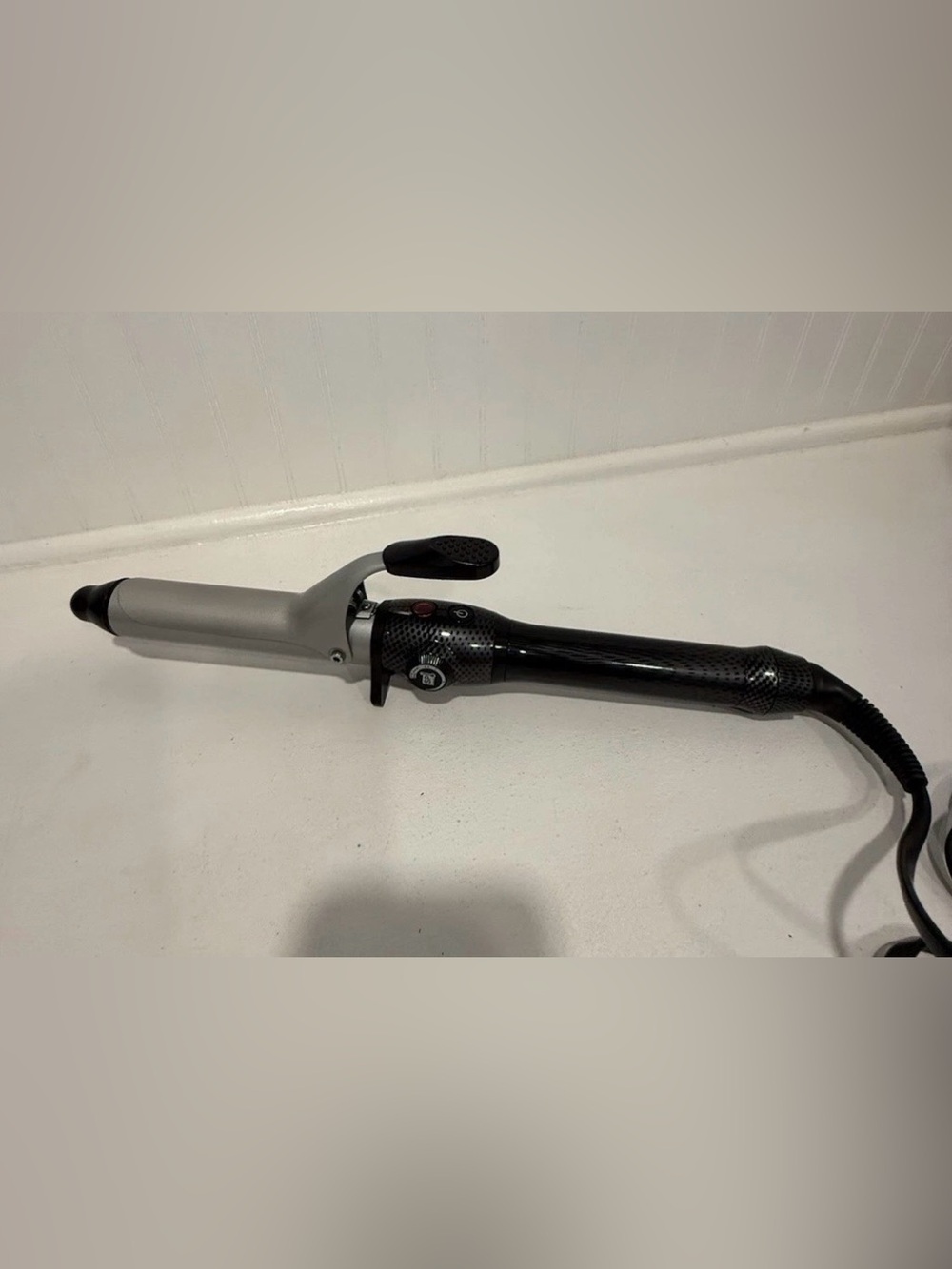 T3 Black and Silver Ceramic Curling Iron with adjustable heat setting.